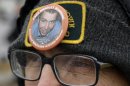 Demonstrator Richard Ochs wears a button in support of Army Pfc. Bradley Manning as he stands outside of Fort Meade, Md., Tuesday, Nov. 27, 2012, where Manning is scheduled to appear for a pretrial hearing. Manning is accused of sending hundreds of thousands of classified Iraq and Afghanistan war logs and more than 250,000 diplomatic cables to the secret-spilling website WikiLeaks while he was working as an intelligence analyst in Baghdad in 2009 and 2010. (AP Photo/Patrick Semansky)