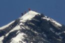 A team of climbers led by 80-year-old Japanese mountaineer Yuichiro Miura stand on the summit of Mount Everest on Thursday, May 23, 2013. Miura on Thursday became the oldest man to reach the top of Mount Everest, a Nepali official and Miura's Tokyo-based support team said. The photo was taken with a telephoto lens from an altitude of 5,550 meters (18,208 feet). It is not clear which of the climbers in the photo is Miura. (AP Photo/Kyodo News) JAPAN OUT, MANDATORY CREDIT