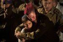 Israeli soldiers and relatives react during the funeral of Cpl. Netanel Yahalomi, 20, in the Israeli city of Modiin, early Sunday, Sept. 23, 2012. Yahalomi was killed Friday in a shootout between Islamic militants and Israeli troops along Israel's southern border with Egypt. The Israeli troops returned fire, killing the militants. (AP Photo/Oded Balilty)