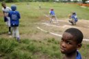 Dominican boys practice baseball at a park in Guerra