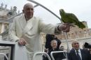 Pope Francis holds a parrot given by faithful during the general audience in Saint Peter's Square at the Vatican