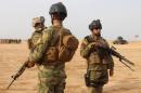 Iraqi security forces stand guard near Fallujah, in Anbar province
