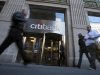Passersby walk in front of a Citibank branch in New York