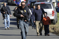 Parents leave a staging area after being reunited with their children following a shooting at the Sandy Hook Elementary School in Newtown, Conn., about 60 miles (96 kilometers) northeast of New York City, Friday, Dec. 14, 2012. An official with knowledge of Friday's shooting said 27 people were dead, including 18 children. It was the worst school shooting in the country's history. (AP Photo/Jessica Hill)