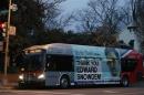 A Washington Metro bus is seen with an Edward Snowden sign on its side panel