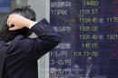A man looks at an electronic stock board of a securities firm in Tokyo, Friday, May 23, 2014. Japan's Nikkei 225 was up 0.9 percent at 14,473.19 after the dollar climbed to near 102 yen overnight. A weaker yen is a plus for Japan's powerhouse export manufacturers. (AP Photo/Koji Sasahara)
