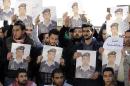 Activists carry posters with a portrait of the Jordanian pilot Maaz al-Kassasbeh during a rally calling for his release in Amman on February 3, 2015