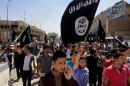 FILE - In this Monday, June 16, 2014 file photo, demonstrators chant pro-Islamic State group slogans as they wave the group's flags in front of the provincial government headquarters in Mosul, 225 miles (360 kilometers) northwest of Baghdad, Iraq. (AP Photo, File)