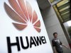 In this Monday, Oct. 8, 2012 photo, a man walks near a logo at a R&D center of Huawei Technologies Inc. in Wuhan, in central China's Hubei province. Eager to expand in the United States, China’s biggest technology companies face American anxiety about security and rising Chinese competition. (AP Photo)  CHINA OUT