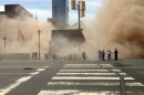 AP10ThingsToSee - A dust cloud rises as people run from the scene of a building collapse on the edge of downtown Philadelphia on Wednesday, June 5, 2013. At least six people were killed and 14 inured after the structure collapsed. (AP Photo/Jordan McLaughlin, File)