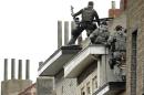 Belgium special force officers prepare to enter a house in the Rue Delaunoy in Molenbeek-Saint-Jean of Brussels, on November 16, 2015