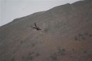 A Turkish military helicopter flies over the border of an area between Iraq and Turkey during a military operation against PKK Kurdish militants