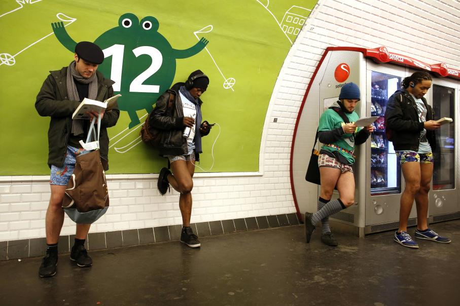 Passengers without their pants wait for a train during the "No Pants Subway Ride" event at a subway station in Paris