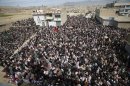 Shi'ite Muslims shout slogans as they protest near the covered bodies (not in picture) of Saturday's bomb attack victims during a sit-in in Quetta
