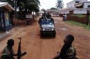 Armed fighters from the Seleka rebel alliance patrol the streets in pickup trucks to stop looting in Bangui