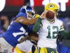New York Giants defensive end Osi Umenyiora (72) knocks the ball away from Green Bay Packers' Aaron Rodgers (12) during the first half of an NFL football game, Sunday, Nov. 25, 2012, in East Rutherford, N.J. (AP Photo/Julio Cortez)
