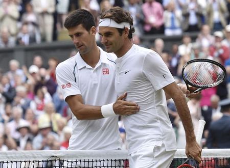 Novak Djokovic of Serbia embraces Roger Federer of Switzerland after winning their Men's Singles Final match at the Wimbledon Tennis Championships in ...
