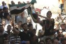 Demonstrators protest against Syria's President Bashar al-Assad after Friday Prayers in Houla