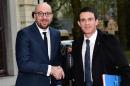 French Prime Minister Manuel Valls (R) is welcomed by his Belgian counterpart Charles Michel at the start of a mini-summit on terrorism, in Brussels, February 1, 2016
