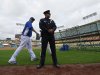 Los Angeles Dodgers starting pitcher Hyun-Jin Ryu, left, of South Korea, walks by a police officer during batting practice before their baseball game against the San Diego Padres, Monday, April 15, 2013, in Los Angeles. (AP Photo/Mark J. Terrill)