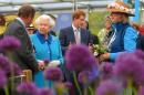 Britain's Queen Elizabeth II (2L) and her grandson Britain's Prince Harry (C) tour the garden exhibits at the 2015 Chelsea Flower Show in London on May 18, 2015