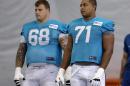 FILE - In this July 24, 2013, file photol, Miami Dolphins guard Richie Incognito (68) and tackle Jonathan Martin (71) stand on the field during NFL football practice in Davie, Fla. Martin, the offensive tackle at the center of the Dolphins' bullying scandal, has been traded to the San Francisco 49ers. The Dolphins announced the deal Tuesday night, March 11, 2014, on the first day of NFL free agency. Martin's move cross country brings him back to the Bay Area to be reunited with his former Stanford coach, Jim Harbaugh. (AP Photo/Lynne Sladky, File)