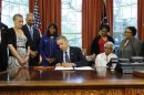 Obama signs a bill designating the Congressional Gold Medal commemorating lives of four young girls killed in 1963 bombing of 16th Street Baptist Church bombing of Birmingham, Alabama, in Washington