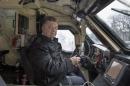 Ukraine's President Petro Poroshenko sits in the driver's seat of an armoured vehicle in Kiev