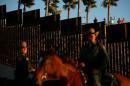 File photo of U.S. Border Patrol agents on horseback patrolling the U.S.-Mexico border fence near San Diego