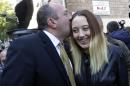 Georgian Dream ruling coalition's presidential candidate Georgy Margvelashvili, left, kisses his daughter Anna, outside a polling station during presidential election in Tbilisi, Georgia, Sunday, Oct. 27, 2013. Georgians are voting Sunday for a president to succeed Mikhail Saakashvili, who during nearly a decade in power has turned this former Soviet republic into a fledgling democracy and a staunch U.S. ally. (AP Photo/Georgy Abdaladze)