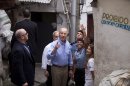 U.S. Vice President Joe Biden, center, speaks with Pacification Unit Major Priscilla Azevedo, gesturing second from right, during his visit to the Santa Marta slum in Rio de Janeiro, Brazil, Thursday, May 30, 2013. Biden is wrapping up his visit to Rio de Janeiro with a visit to a slum before traveling to Brasilia for a Friday meeting with Brazilian President Dilma Rousseff. (AP Photo/Victor R. Caivano)