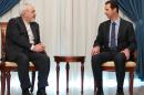 In this photo released by the Syrian official news agency SANA, Iranian Foreign Minister Mohammad Javad Zarif, left, meets with Syrian President Bashar Assad, right, in Damascus, Syria, Wednesday, Jan. 15, 2014. Assad and Zarif have held talks about next week's United Nations conference in Montreux, Switzerland, aimed at trying to resolve the three-year deadly conflict. (AP Photo/SANA)