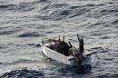 This handout picture released by the EU Navfor on January 13, 2012 shows six Somali men surrendering to members of the EU NAVFOR flagship, the ESPS Patino, off the coast of Mogadishu