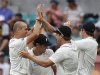 Teammates congratulate New Zealand's Martin after he took the wicket of Austrtalia's Hughes during the second test in Hobart