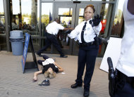 A demonstrator lies on the ground at an entrance to the National Air and Space Museum in Washington after police pepper-sprayed a group of protestors trying to get into the museum Saturday, Oct. 8, 2011, as part of Occupy DC activities in Washington. (AP Photo/Jose Luis Magana)