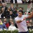 Federer of Switzerland hits a return to Carreno-Busta of Spain during their men's singles match at the French Open tennis tournament in Paris