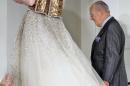 FILE - In this Feb. 4, 2008, file photo, designer Oscar de la Renta is applauded after the presentation of his fall 2008 collection during Fashion Week in New York. The designer, who died Monday, Oct. 20, 2014, at 82, shaped American couture half a century ago when it emerged as a serious rival to European fashion designers. (AP Photo/Richard Drew, File)