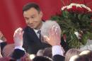 Opposition candidate Andrzej Duda celebrates with supporters as the first exit polls in the presidential runoff voting are announced, in Warsaw, Poland, Sunday, May 24, 2015. Polish President Bronislaw Komorowski conceded defeat in the presidential election Sunday after an exit poll showed him trailing Duda, a previously little-known right-wing politician. (AP Photo/Czarek Sokolowski)