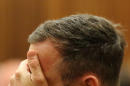 Oscar Pistorius gestures as he sits in court as the sentencing process entered a second day, Pretoria, South Africa, Tuesday Oct. 14, 2014. Pistorius was being portrayed as a "poor victim" ahead of his sentencing for killing girlfriend Reeva Steenkamp, the chief prosecutor said Tuesday. (AP Photo/Themba Hadebe, Pool)