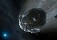 Projeção divulgada em 10 de outubro de 2013 pela Universidade de Warwick mostra asteroide rico em água sendo puxado pela intensa gravidade da estrela anã GD 61