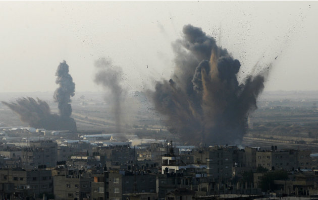 Smoke rises following an Israeli attack on smuggling tunnels on the border between Egypt and Rafah, southern Gaza Strip, Monday, Nov. 19, 2012. (AP Photo/Eyad Baba)