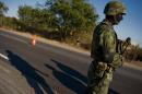 A Mexican soldier stands guard in a checkpoint of the road that links Navolato and Los Mochis, in Sinaloa State, Mexico on January 29, 2012
