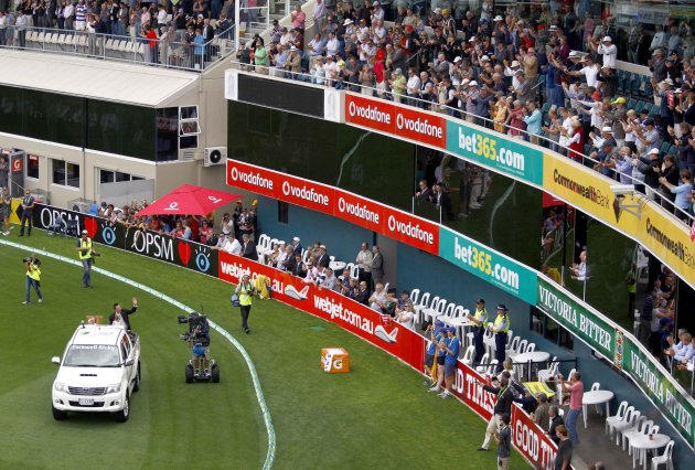 Former Australian cricket team captain Ponting waves to the crowd as he passes them in a vehicle on a lap of honour after he retired recently from international cricket at Bellerive Oval in Hobart