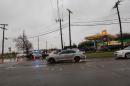 Police divert traffic away from a damaged area after a tornado in Garland, Texas on December 27, 2015