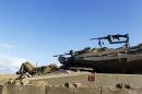 Israeli soldiers rest atop tanks outside the central Gaza Strip