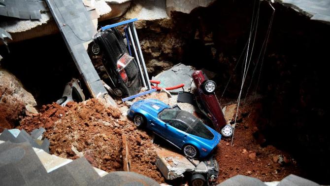  This Feb. 12, 2014 file photo shows a view of a sinkhole that opened up in the Skydome showroom at the National Corvette Museum in Bowling Green, Ky. Eight display cars were swallowed by the hole. (AP Photo/Michael Noble Jr., File)