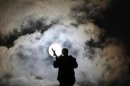 A statue is silhouetted in Saint Peter's Square at the Vatican