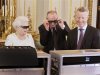 Britain's Queen Elizabeth watches a preview of her Christmas message with a pair of 3D glasses in London