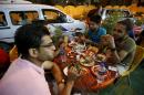 Iraqi youths eat the pre-dawn Suhoor meal before the start of the daily Ramadan fast in a restaurant in Baghdad