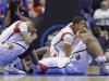 Louisville's Peyton Siva, left, Chane Behanan, center, and Wayne Blackshear (20) react to LKevin Ware's injury during the first half of the Midwest Regional final in the NCAA college basketball tournament, Sunday, March 31, 2013, in Indianapolis. (AP Photo/Michael Conroy)